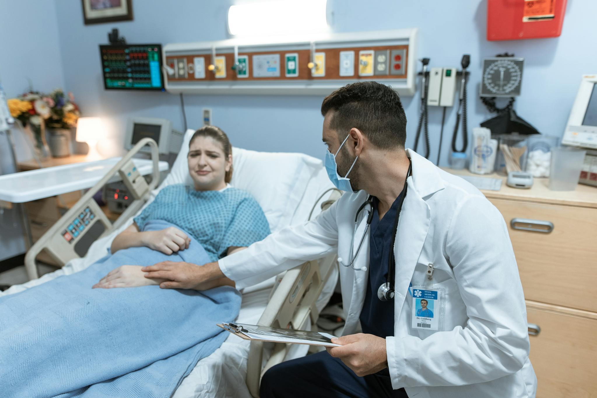 A doctor comforts an ill patient in a hospital room, embodying care and compassion.